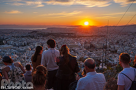 Photo : Touristes regardant le coucher de soleil sur Athènes au sommet du Mont Lycabette, Grèce